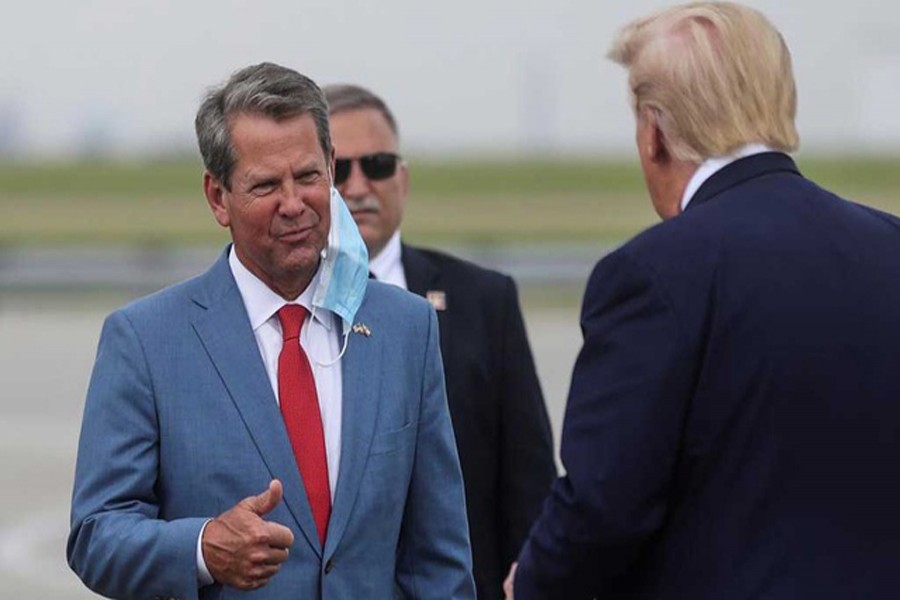 FILE PHOTO: US President Donald Trump is greeted by Georgia Governor Brian Kemp as he arrives at Hartsfield-Jackson Atlanta International Airport in Atlanta, Georgia, US, July 15, 2020. REUTERS   
