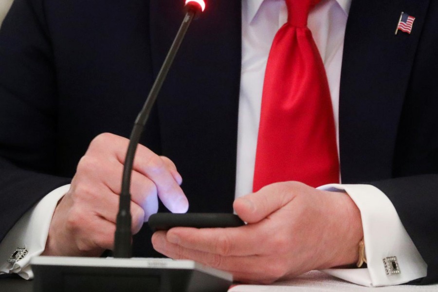 U.S. President Donald Trump taps the screen on a mobile phone at the approximate time a tweet was released from his Twitter account, during a roundtable discussion on the reopening of small businesses in the State Dining Room at the White House in Washington, US on June 18, 2020 — Reuters/Files