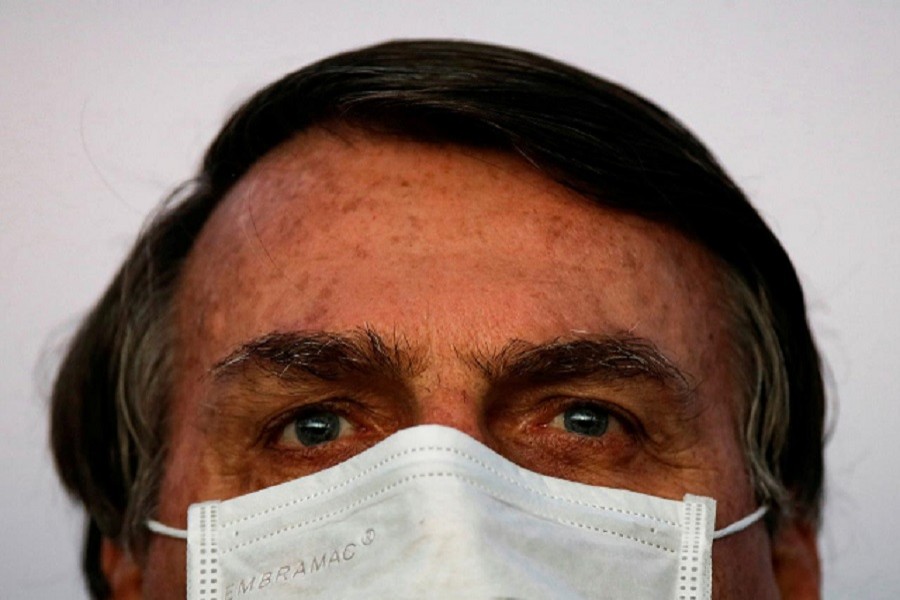 Brazil's President Jair Bolsonaro looks on during a ceremony of lowering the national flag for the night, amid the coronavirus disease (Covid-19) outbreak, at the Alvorada Palace in Brasilia, Brazil, July 18, 2020 — Reuters