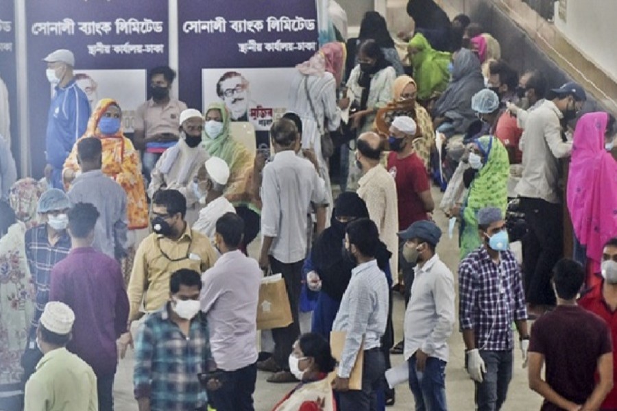 Customers queue up at the principal branch of state-owned Sonali Bank in Dhaka’s Motijheel commercial area on Tuesday as the government gradually starts to ease the lockdown rules during the coronavirus crisis.