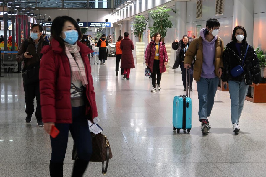Passengers wearing masks are seen at the terminal hall of the Beijing Capital International Airport, in Beijing, China on January 23, 2020 — Reuters/Files