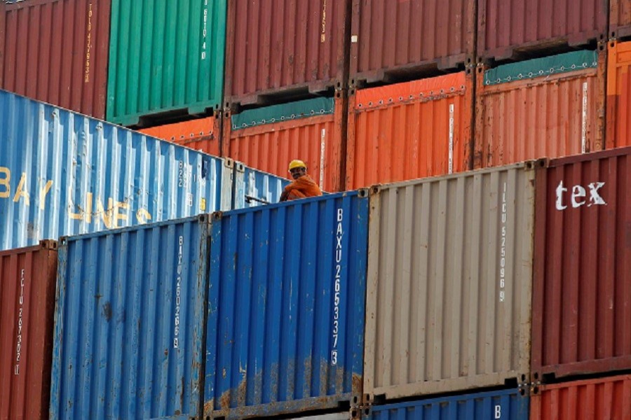 A worker sits on a ship carrying containers at Mundra Port in the western Indian state of Gujarat April 01, 2014 — Reuters/Files