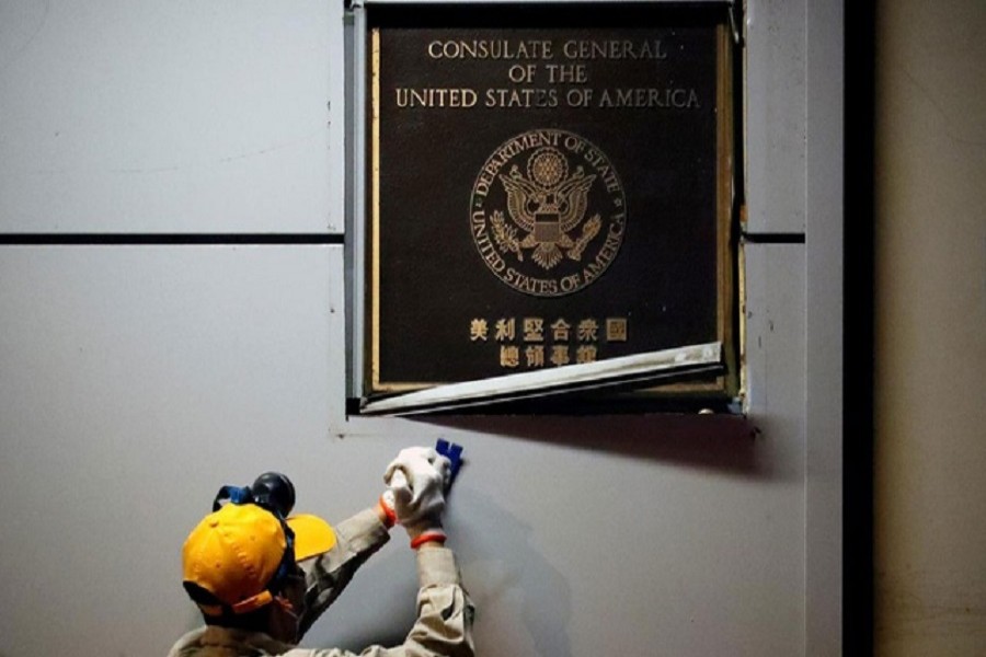 A man works to remove the US Consulate plaque at the US Consulate General in Chengdu, Sichuan province, China, July 26, 2020 — Reuters