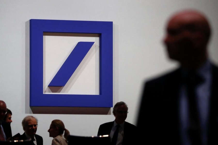FILE PHOTO: Employees of Deutsche Bank gather ahead of the bank’s annual shareholder meeting in Frankfurt, Germany, May 23, 2019. REUTERS/Kai Pfaffenbach/File Photo