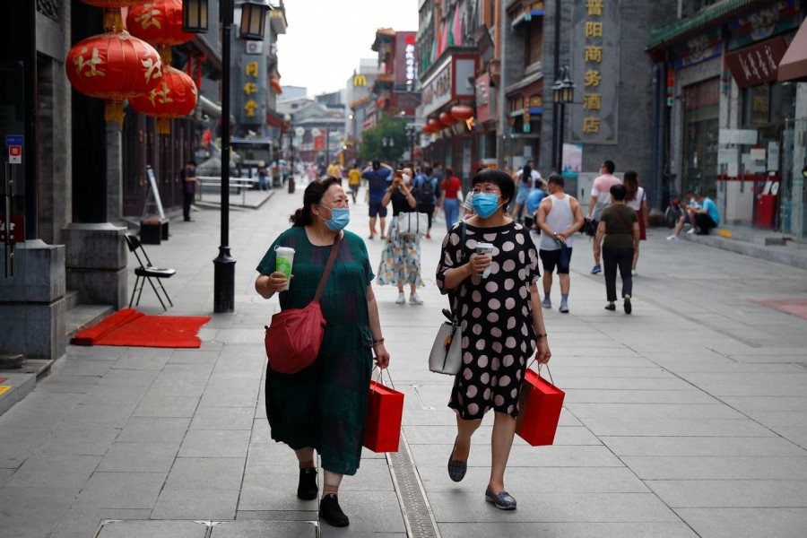 People wear protective masks as they walk in a shopping street following the outbreak of the coronavirus disease (Covid-19) in a historic part of Beijing, China on July 30, 2020 — Reuters photo