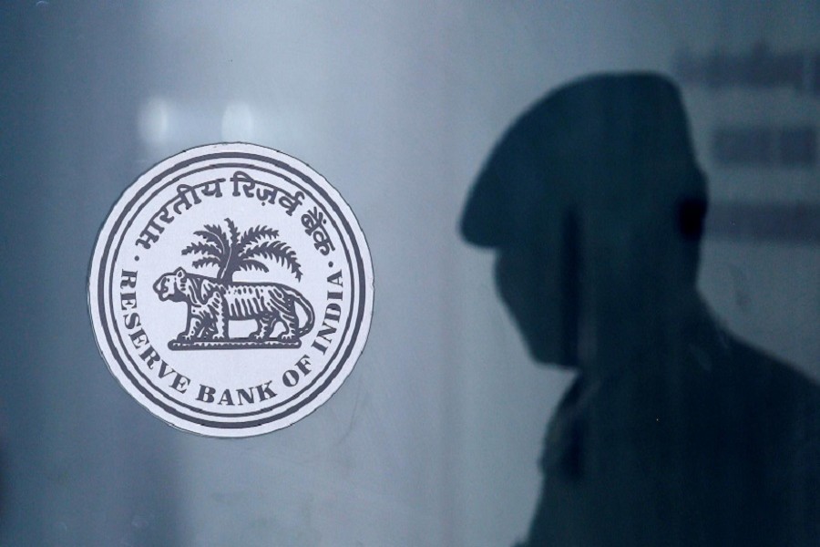 A security guard's reflection is seen next to the logo of the Reserve Bank Of India (RBI) at the RBI headquarters in Mumbai, India, June 6, 2019 — Reuters/Files