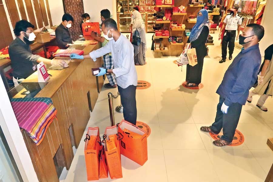 Customers maintain social distancing while doing shopping at an Aarong outlet at Wari in Dhaka city, May 10, 2020 — FE Photo/Files