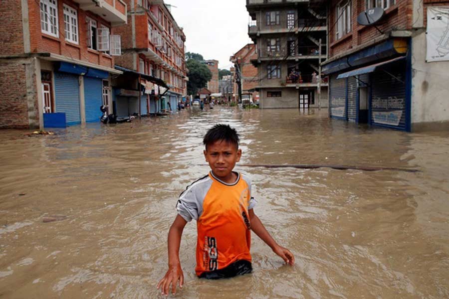 A boy walking along the flooded neighbourhood after incessant rainfall in Nepal last month –Reuters Photo