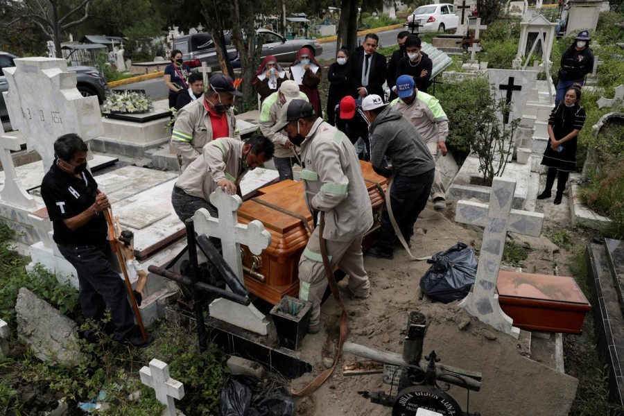 Cemetery workers move the coffin of a man, who died of the coronavirus disease (Covid-19), during his funeral at the San Nicolas Tolentino cemetery in the Iztapalapa neighbourhood in Mexico City, Mexico on August 4, 2020 — Reuters photo