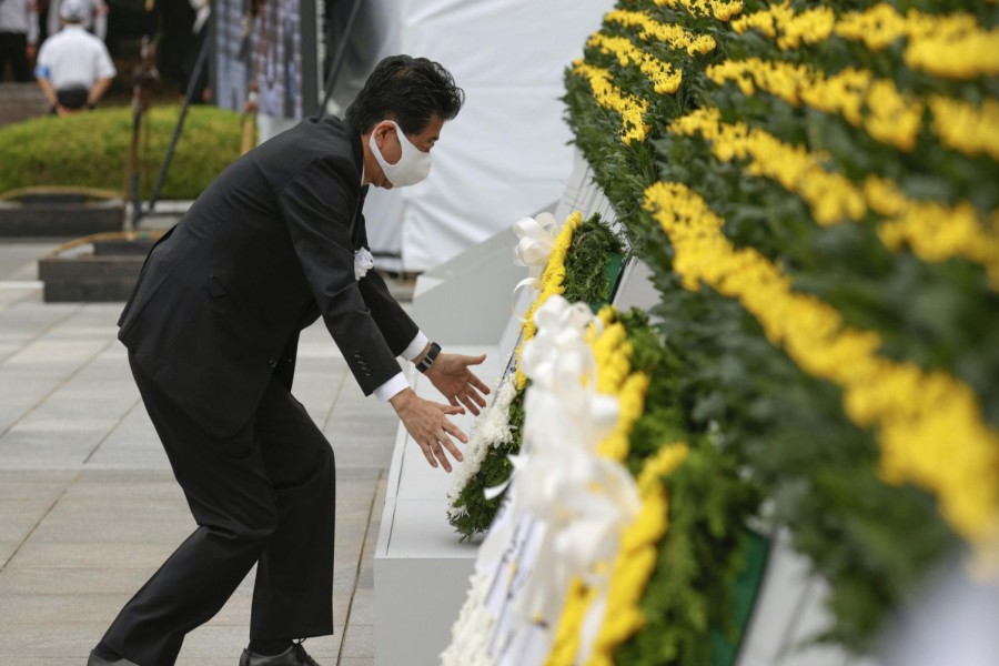 Japan's Prime Minister Shinzo Abe wearing a protective face mask, offers a wreath to the cenotaph for the victims of the 1945 atomic bombing, at Peace Memorial Park in Hiroshima, western Japan, August 6, 2020, on the 75th anniversary of the atomic bombing of the city. Mandatory credit Kyodo/via REUTERS