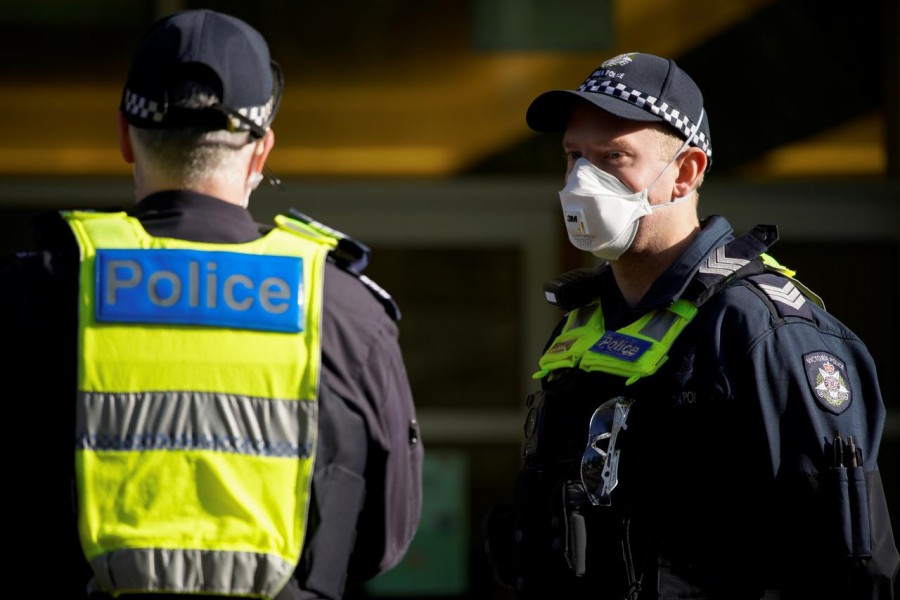Victoria Police officers meet outside a public housing tower, locked down in response to an outbreak of the coronavirus disease (Covid-19), in Melbourne, Australia on July 8, 2020 — Reuters/Files