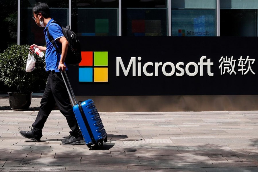 A person walks past a Microsoft logo at the Microsoft office in Beijing, China, August 04, 2020 — Reuters