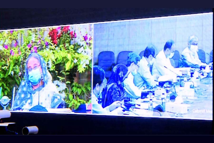 Prime Minister Sheikh Hasina presiding over weekly cabinet meeting through a videoconference from Ganabhaban on Monday, while other cabinet members got connected from the secretariat  -PID Photo