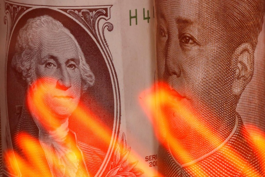 US dollar and Chinese Yuan banknotes are seen behind illuminated stock graph in this illustration taken on February 10, 2020 — Reuters/Files