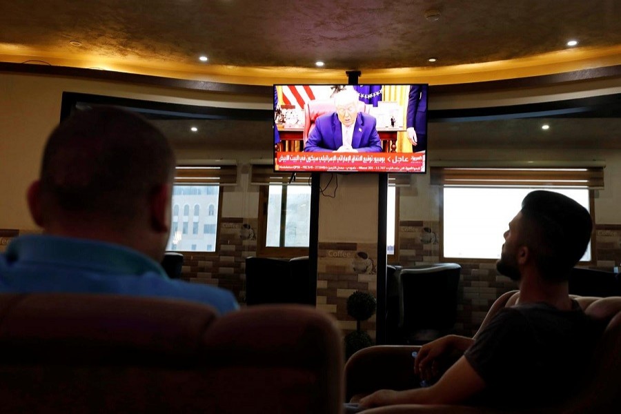 A television screen shows US President Donald Trump as Palestinians follow the news on UAE 's agreement with Israel on normalising relations, in Hebron in the Israeli-occupied West Bank, August 13, 2020 — Reuters