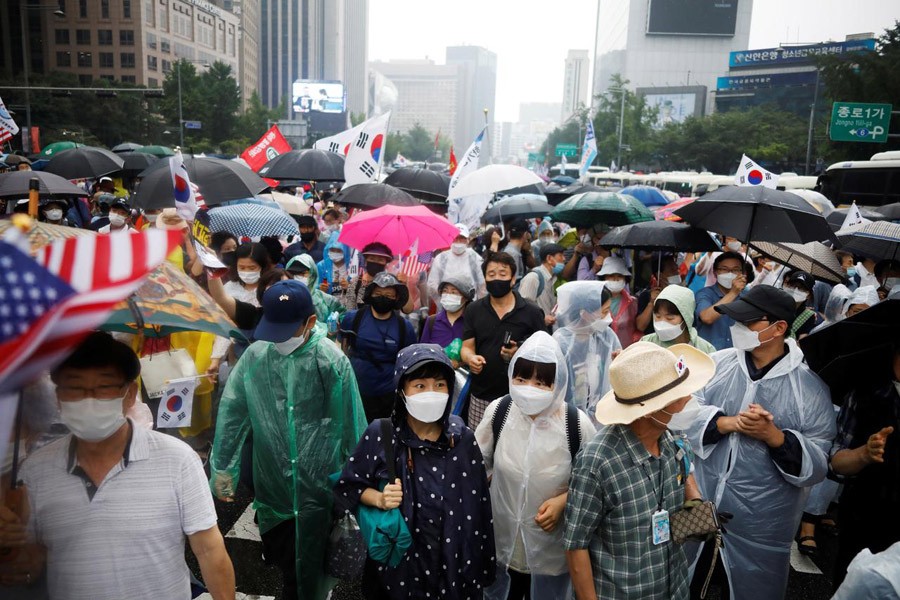 Members of conservative civic groups march down a street during an anti-government protest, as concerns over a fresh wave of the coronavirus disease (COVID-19) cases grow, in central Seoul, South Korea, August 15, 2020. REUTERS/Kim Hong-Ji