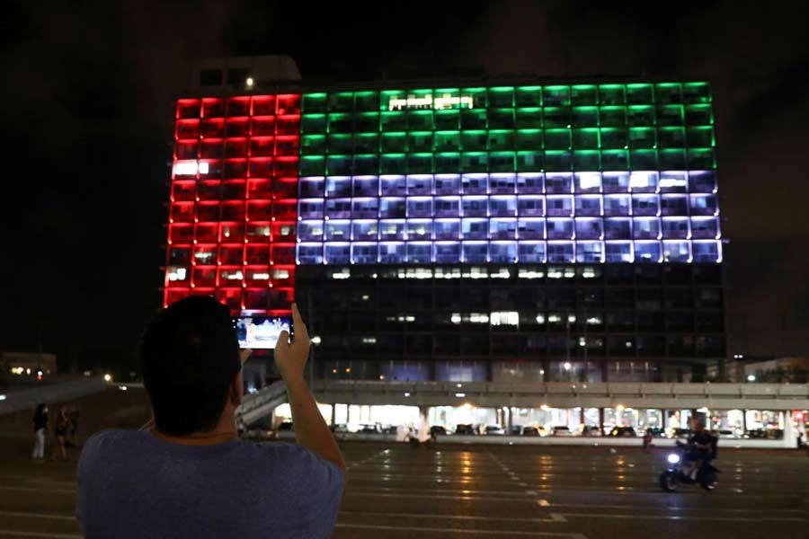 A man taking a picture as the municipality building is lit in the United Arab Emirates national flag following the announcement of a deal to normalise relations between the Jewish state and the United Arab Emirates, in Tel Aviv, Israel recently –Reuters Photo
