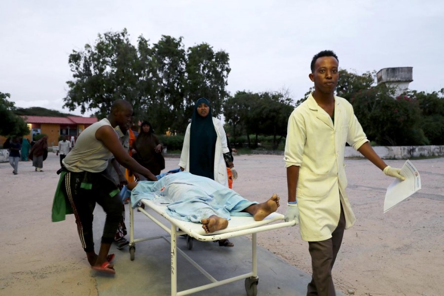 Civilians assist an injured person at Madina hospital after a blast at the Elite Hotel in Lido beach in Mogadishu, Somalia on August 16, 2020 — Reuters photo