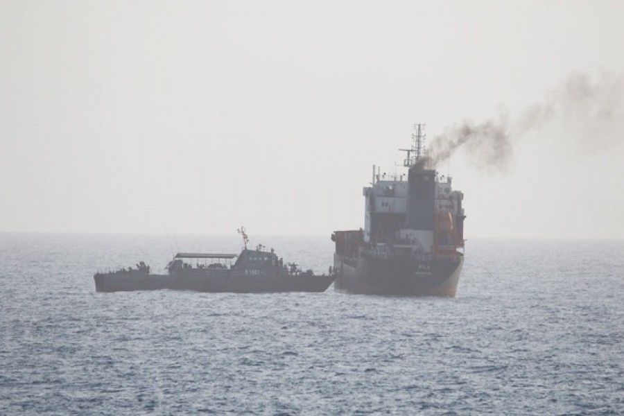 This picture released by the US Navy allegedly shows a ship of the Iranian Navy and members of the Iranian forces boarding civilian tanker WILA en-route to the UAE, in international waters in the Strait of Hormuz, August 12, 2020. US NAVY/Handout via REUTERS
