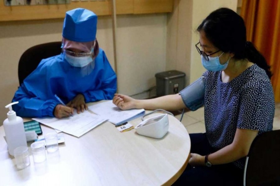 A healthcare worker checks the tension of a volunteer during a simulation for coronavirus vaccine clinical trials next week at the Faculty of Medicine at Padjadjaran University amid the COVID-19 pandemic in Bandung, Indonesia, Aug 6, 2020. REUTERS