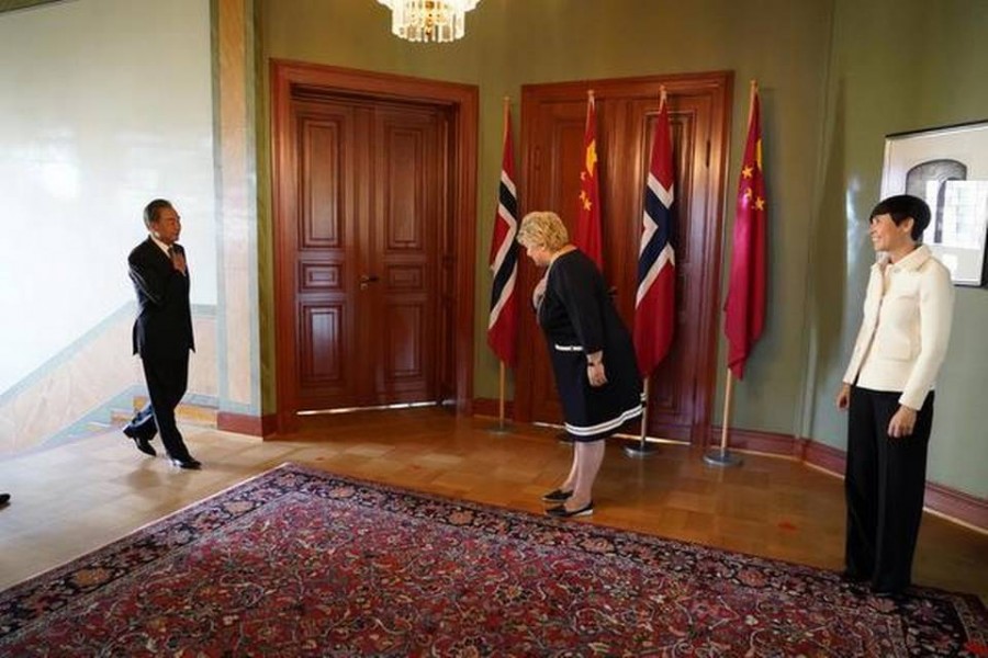 Norwegian Prime Minister Erna Solberg and Foreign Minister Ine Eriksen Soreide greet Chinese Foreign Minister Wang Yi during his short courtesy visit to Norway, in Oslo, on Thursday. REUTERS   -  via REUTERS