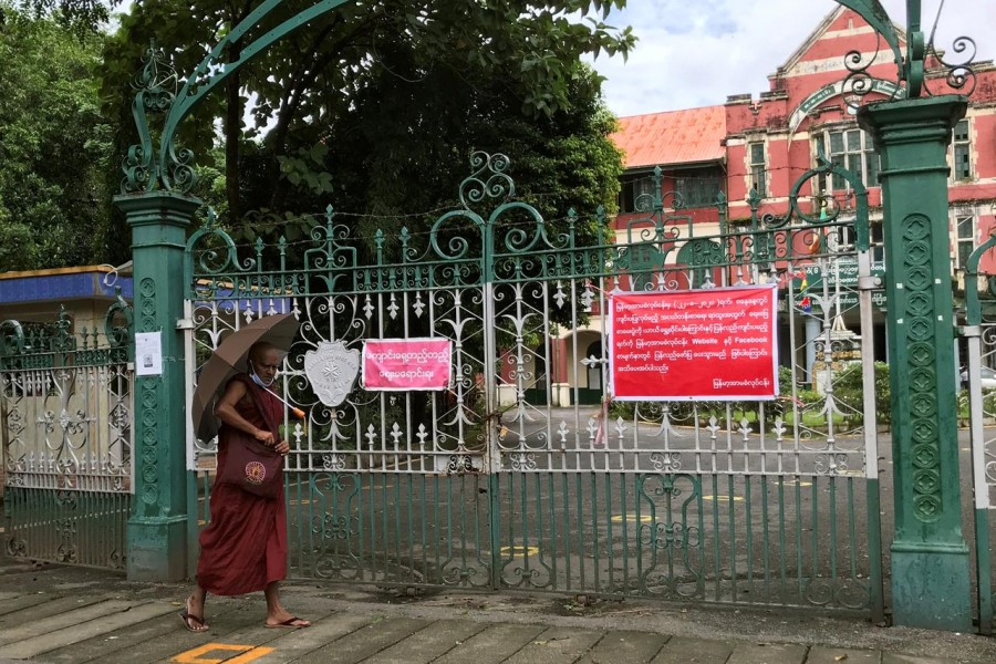 A Buddhist monk walks past a closed school amid the outbreak of the coronavirus disease (COVID-19), in Yangon August 27, 2020. REUTERS/Zaw Naing Oo