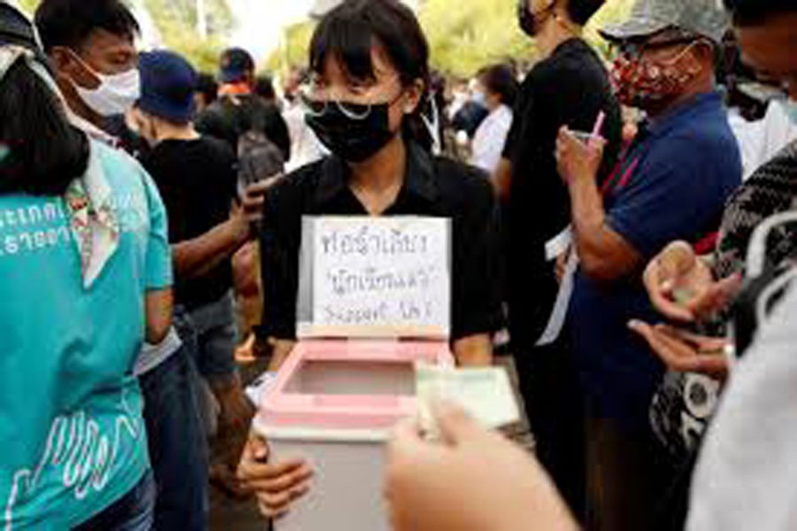 A woman collects donations as anti-government protesters and students attend a demonstration demanding the government to resign, in front of the Ministry of Education in Bangkok, Thailand September 05, 2020. REUTERS/Jorge Silva