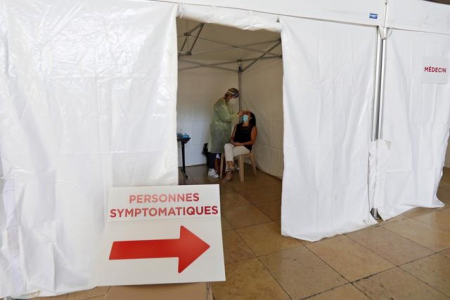 A medical worker, wearing protective suit and face mask, administers a nasal swab to a patient in a testing site for coronavirus disease (Covid-19) in Nice, France on September 7, 2020. The sign reads "symptomatic people" — Reuters photo