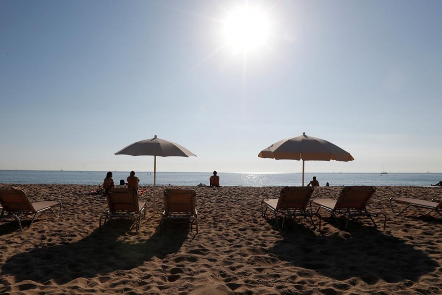People sunbathe on a hot day in Barceloneta beach in Barcelona, Spain — Reuters file photo used only for representation