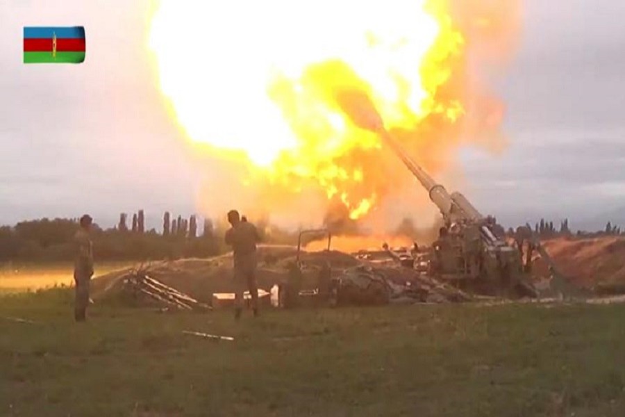 A still image from a video released by the Azerbaijan's Defence Ministry shows members of Azeri armed forces firing artillery during clashes between Armenia and Azerbaijan over the territory of Nagorno-Karabakh in an unidentified location, in this still image from footage released September 28, 2020 —Defence Ministry of Azerbaijan/Handout via Reuters