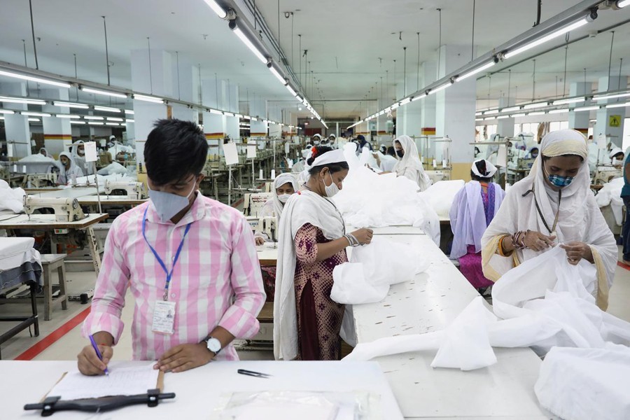 Bangladeshi garment workers make protective suit at a factory amid concerns over the spread of the coronavirus disease (Covid-19) in Dhaka, Bangladesh on March 31, 2020 — Reuters/Files