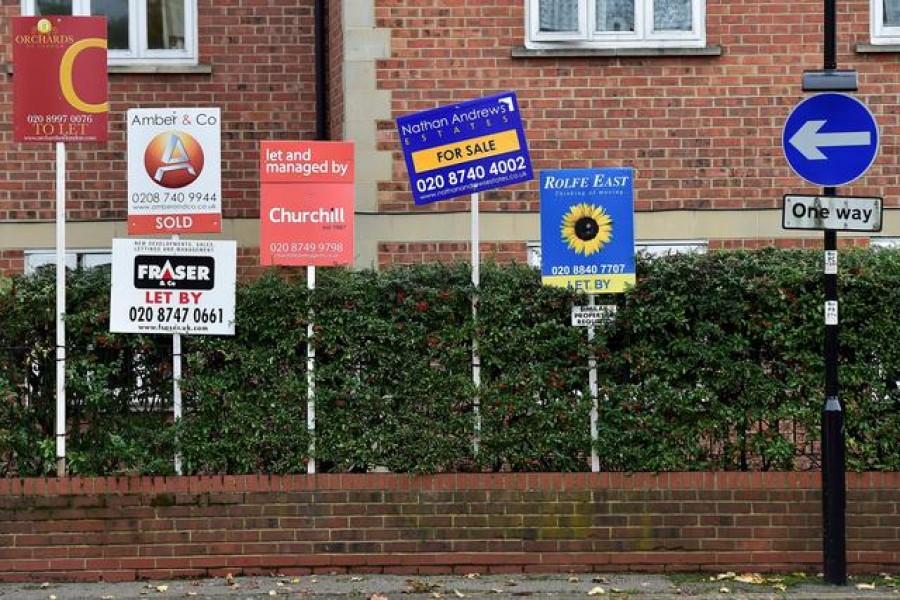 Property sale and rental signs are seen next to a street sign in London — Reuters/Files