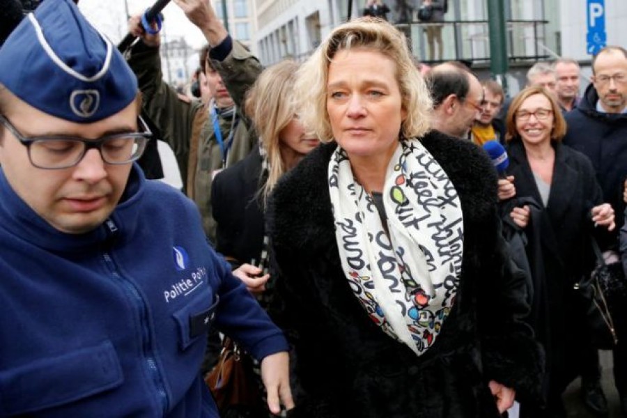 Belgian artist Delphine Boel is escorted by police officers as she leaves a courthouse, after a hearing in her legal battle to prove former Belgian King Albert is her father, in Brussels, Belgium February on 21, 2017 — Reuters/Files