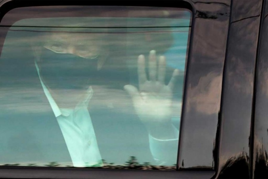 Doctors treating President Donald Trump for Covid-19 sent conflicting signals about the severity of his condition on Sunday, hours before the president surprised supporters gathered outside the hospital with an impromptu motorcade.