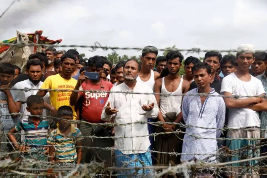 Rohingya refugees gather near the fence at the 'no man's land' zone in Maungdaw district in Myanmar's Rakhine State in 2018 (File:EPA)