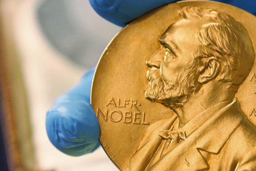 In this April 17, 2015 file photo, a national library employee shows a gold Nobel Prize medal in Bogota, Colombia. (AP Photo/Fernando Vergara, File)