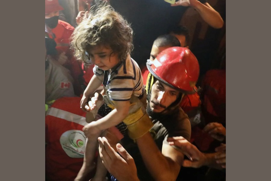 Rescuers carry a child that was evacuated from a building after a fuel tank exploded in the al-Tariq al-Jadida neighborhood of Beirut, Lebanon October 9, 2020. REUTERS/Mohamed Azakir