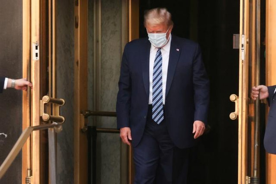 US President Donald Trump walks out the front doors of Walter Reed National Military Medical Center after a fourth day of treatment for the coronavirus disease (Covid-19) to return to the White House in Washington from the hospital in Bethesda, Maryland, US, October 5, 2020 — Reuters