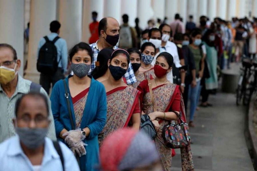 People wearing protective face masks stand in a line to enter a metro station amidst the spread of the coronavirus disease (COVID-19), in New Delhi, India, Sept 14, 2020. REUTERS