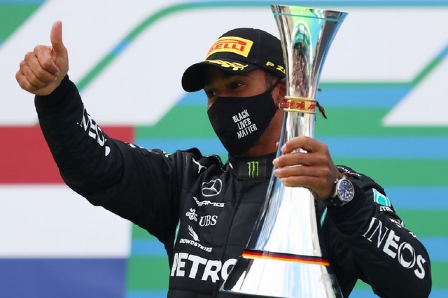 Formula One F1 - Eifel Grand Prix - Nurburgring, Nurburg, Germany - October 11, 2020 Mercedes' Lewis Hamilton celebrates with a trophy on the podium after winning the race Pool via REUTERS