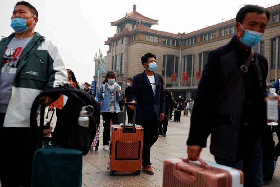 People arrive at Beijing Railway Station after an eight-day National Day holiday following the outbreak of the coronavirus disease (Covid-19) in Beijing, China, October 9, 2020 — Reuters/Files
