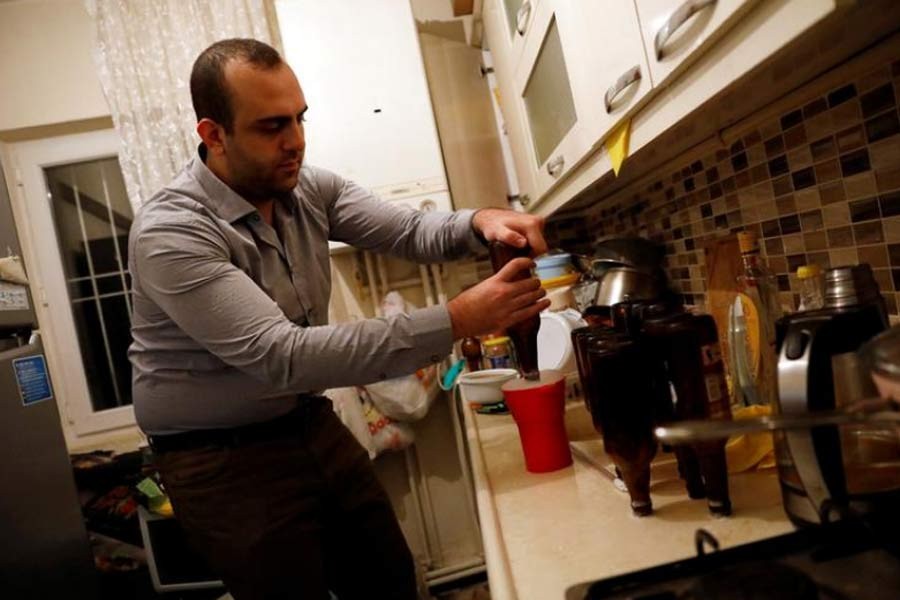 Onder Ceyhan, a 25-year old university student, is preparing his own beer at his home in Ankara. The photo was taken in 2017. –Reuters file photo