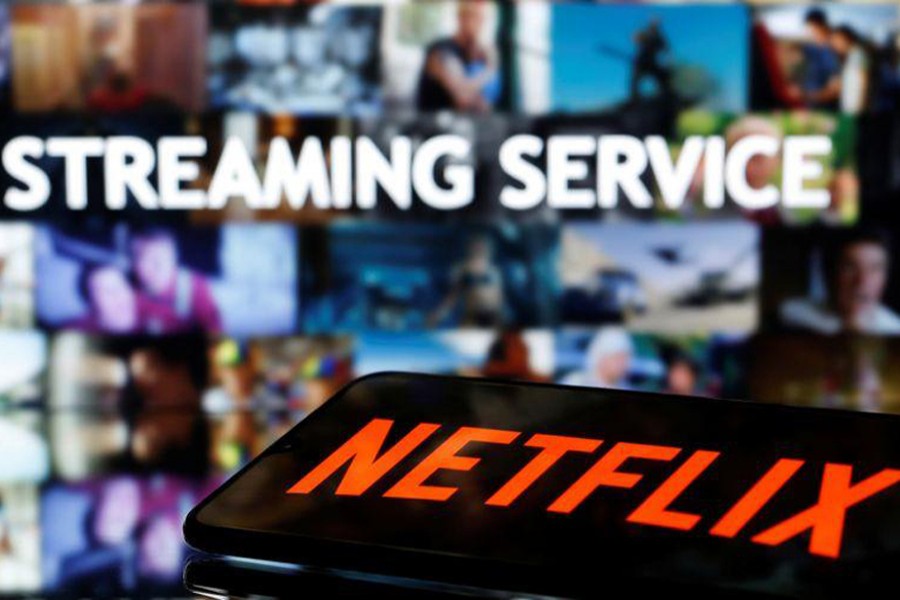 A smartphone with the Netflix logo lies in front of displayed "Streaming service" words in this illustration taken on March 24, 2020 — Reuters/Files