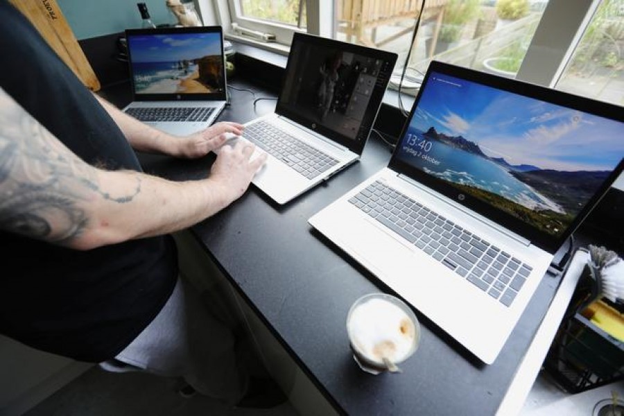 FILE PHOTO: A man works in his kitchen during the coronavirus disease (COVID-19) outbreak in Sassenheim, Netherlands October 2, 2020. REUTERS/Eva Plevier