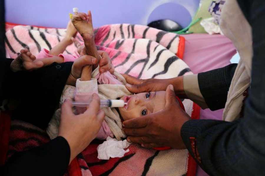 A health worker feeding a malnourished girl at the malnutrition department of the al-Sabeen Maternity and Child Hospital in Sanaa of Yemen on August 19 this year –Reuters file photo