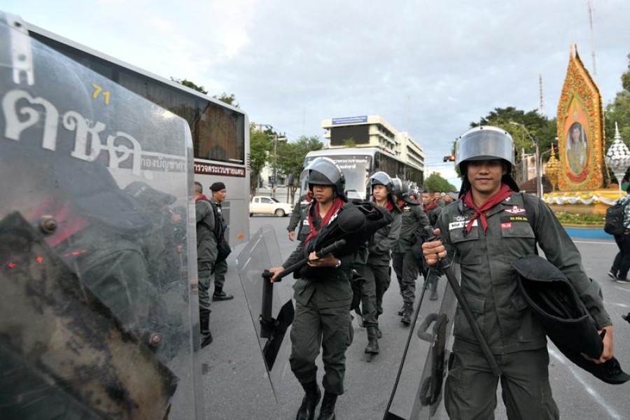 Police officers walk with their riot gear after a mass anti-government protest, on the 47th anniversary of the 1973 student uprising, in Bangkok, Thailand October 15, 2020. REUTERS/Chalinee Thirasupa