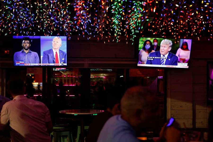 The dual town halls of US Democratic presidential candidate Joe Biden and US President Donald Trump, who are both running in the 2020 US presidential election, are seen on television monitors at Luv Child restaurant ahead of the election in Tampa, Florida, US on October 15, 2020 — Reuters photo