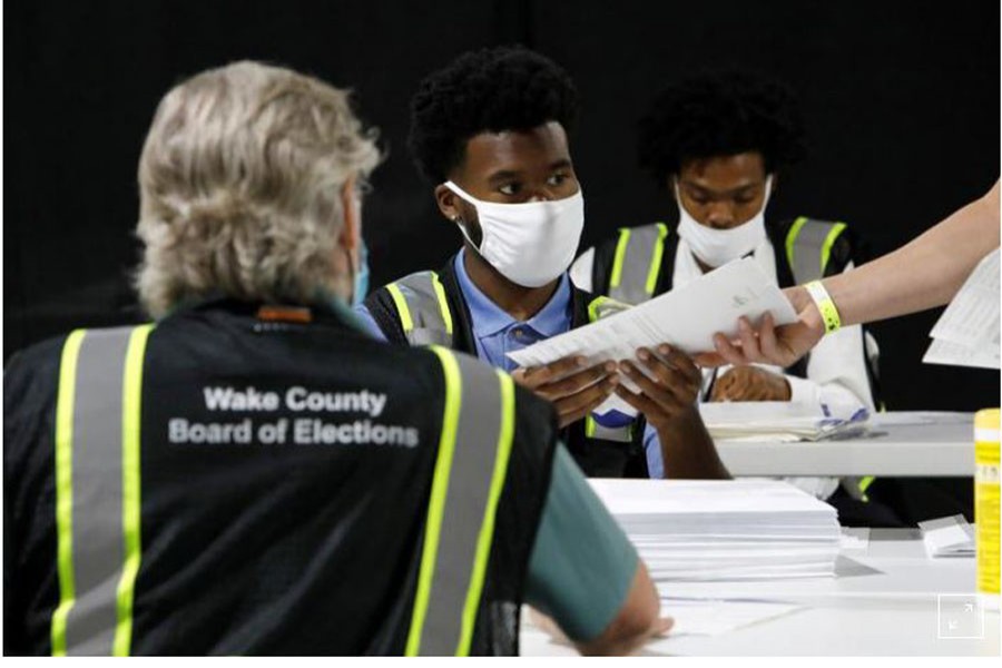 FILE PHOTO: Poll workers prepare absentee ballots for shipment at the Wake County Board of Elections on the first day that the state started mailing them out, in Raleigh, North Carolina, U.S. September 4, 2020. REUTERS/Jonathan Drake
