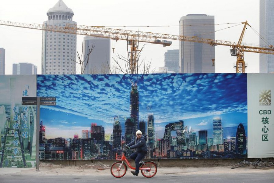 A man cycles outside the construction sites in Beijing's central business area, China, January 18, 2019 — Reuters/Files