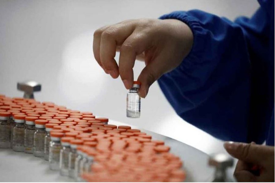 A worker performs a quality check in the packaging facility of Chinese vaccine maker Sinovac Biotech, developing an experimental coronavirus disease (COVID-19) vaccine, during a government-organised media tour in Beijing, China, Sept 24, 2020. REUTERS